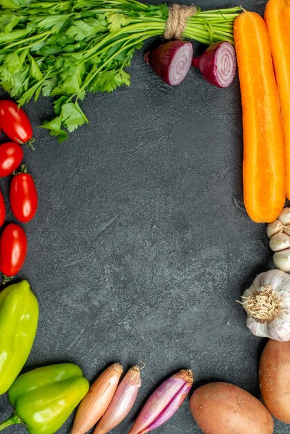Top close view of vegetables in square on dark grey background