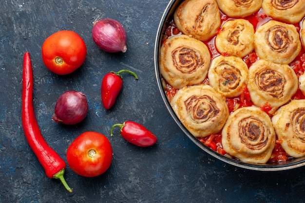 top closer view of delicious dough meat inside pan along with fresh vegetables such as onions tomatoes peppers on dark