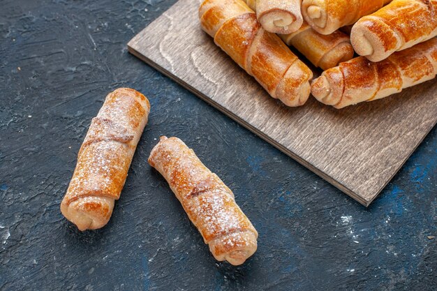 top closer view of delicious sweet bangles with filling yummy baked on dark