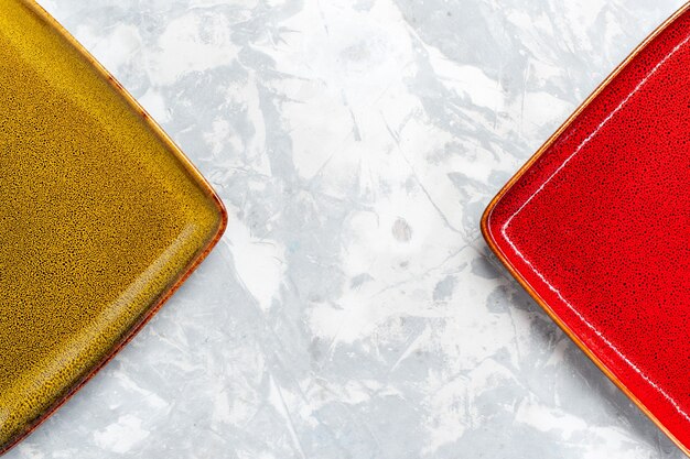 Top closer view empty square plates red and olive colored on white surface plate kitchen food photo cutlery color