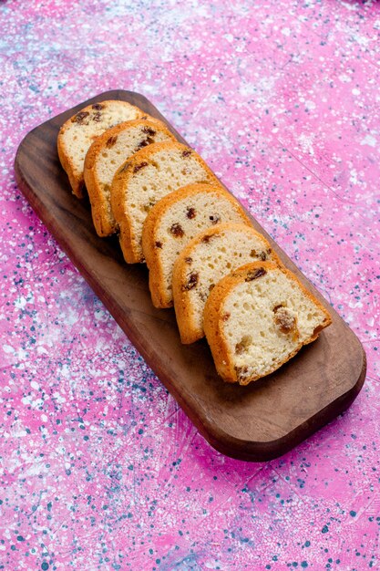 Top distant view delicious raisin cake sliced pie on the pink surface bake pie sugar sweet biscuit cookie color