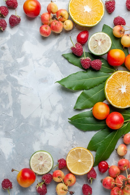 Top distant view lemons and cherries fresh fruits on light-white desk fruit fresh mellow ripe