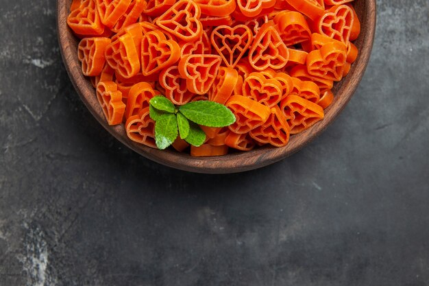 Top half view heart shaped red italian pasta