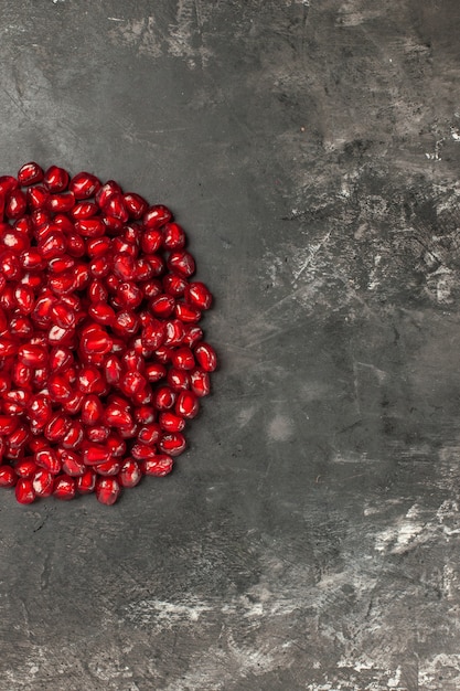 Top half view pomegranate seeds on dark background