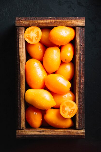 Top lay delicious tomatoes in a basket