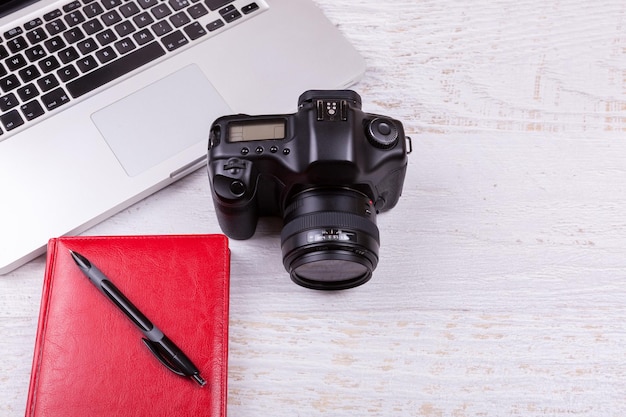 Free photo over top photo of dslr digital camera and laptop on wooden background