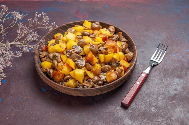 Top side view bowl of potatoes with mushrooms bowl of potatoes and mushrooms and a fork on the dark surface