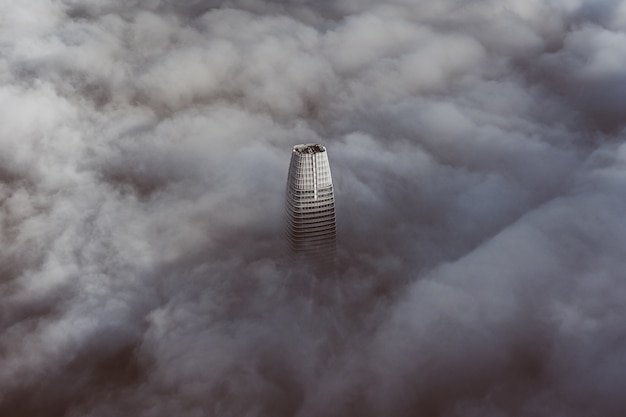 The top of the tallest building in San Francisco enveloped with clouds