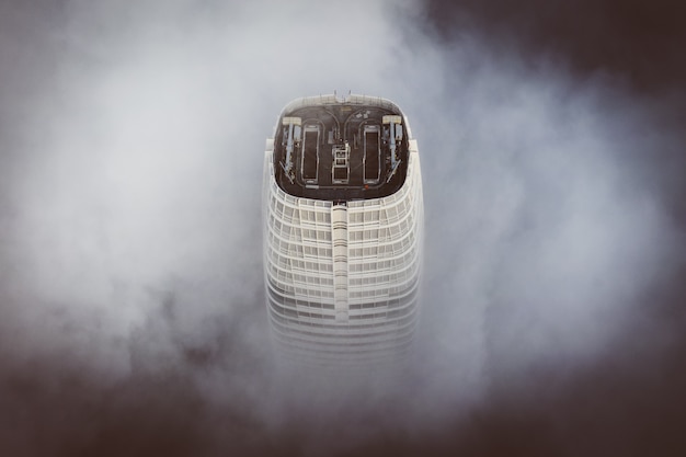 The top of the tallest building in San Francisco enveloped with clouds