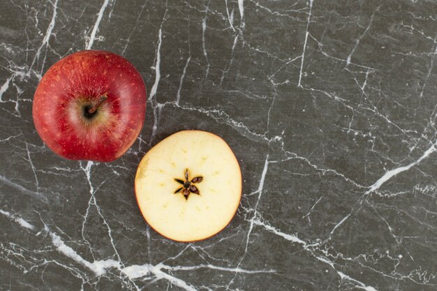 Top up view of fresh red apple. whole and sliced.