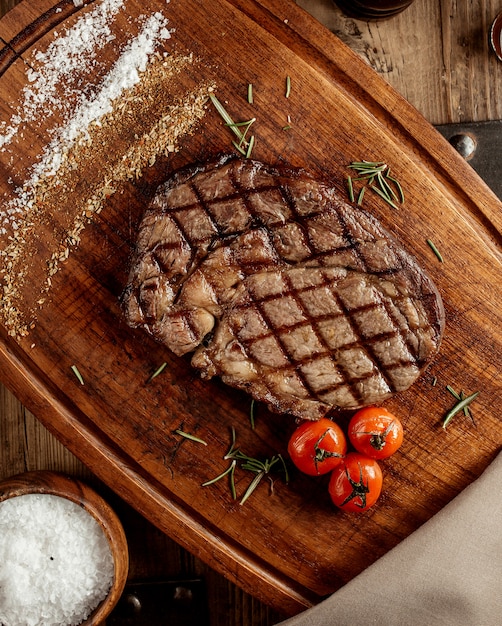 Top veiw of grilled beef steak served on wooden board