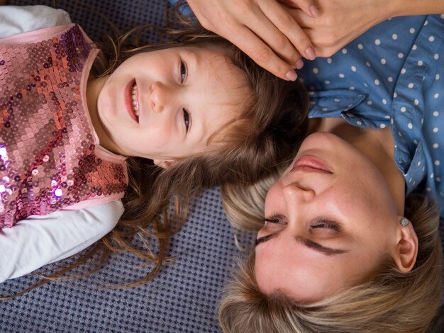 Top view adorable young girl and mother together