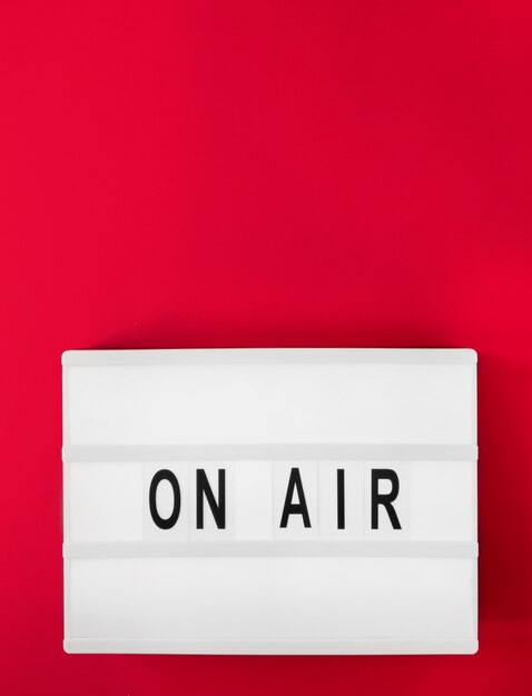 Top view on air sign with red background
