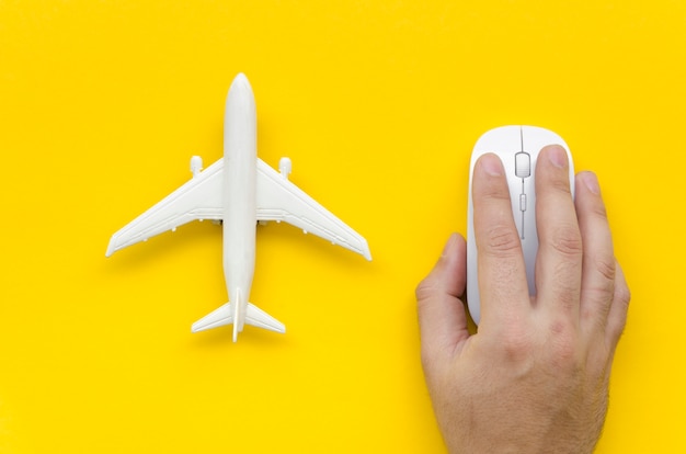 Free photo top view airplane beside hand with mouse