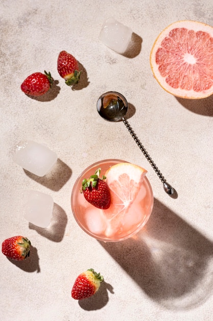 Top view alcoholic drink with grapefruit and strawberries