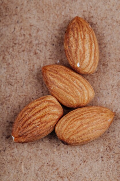 Top view of almond nuts on old paper texture background
