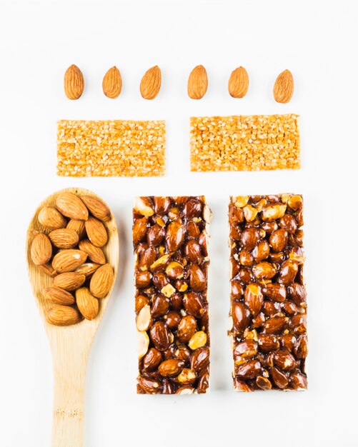 Top view of almond and sesame energy bars on white background