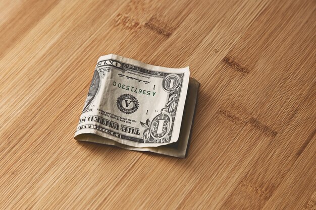 top view of an American dollar bill on a wooden surface
