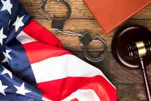 Free photo top view american flag with handcuffs and gavel
