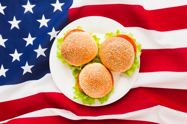 Top view of american flag with plate of burgers