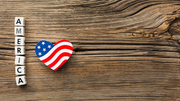 Top view of american heart-shaped flag on wood