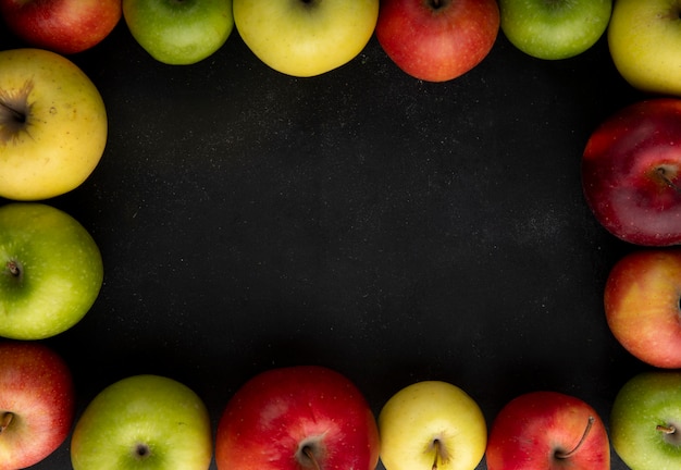 Top view apple mix green yellow and red apples with copy space on black background