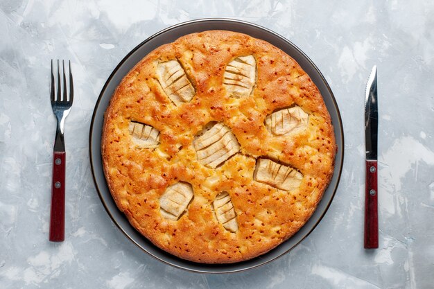 Top view apple pie inside pan on the light background sugar cake biscuit sweet bake