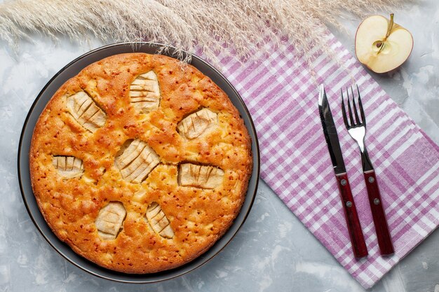 Top view apple pie inside pan on the light desk sugar cake biscuit pie sweet bake