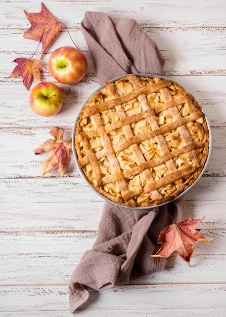 Top view of apple pie for thanksgiving with autumn leaves