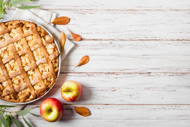 Top view of apple pie for thanksgiving with leaves and copy space