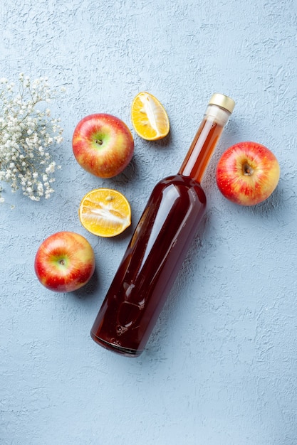 Top view apple vinegar in bottle on white table juice fruit color photo red fresh sour food