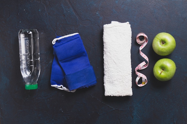 Top view of apples with towel and water bottle