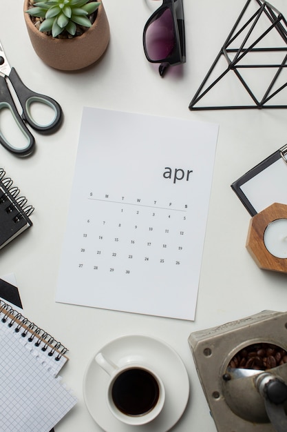 Top view april calendar and coffee cup