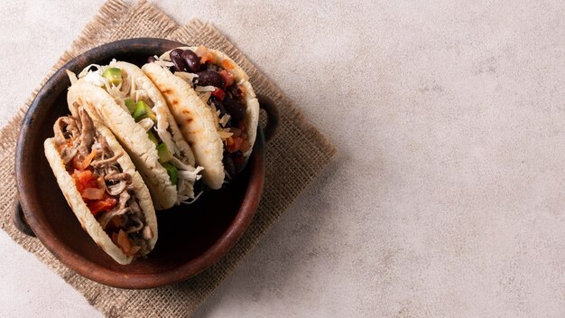 Top view arepas in bowl with copy-space