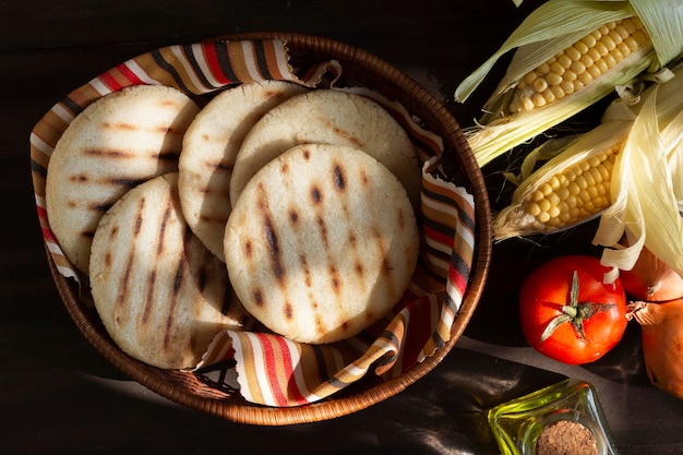 Free photo top view arepas and vegetables assortment