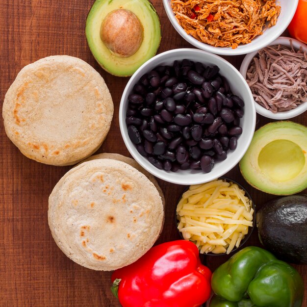Top view of arepas with filling ingredients