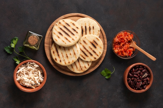 Free photo top view arepas on wooden board