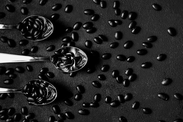 Top view arrangement of black beans on dark background