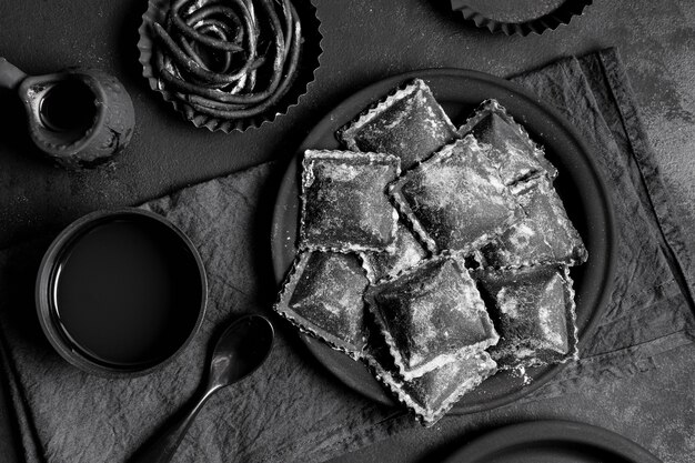 Top view arrangement of black delicious food on dark table