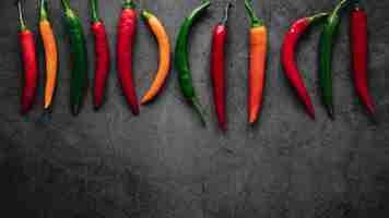 Free photo top view arrangement of chili peppers copy space