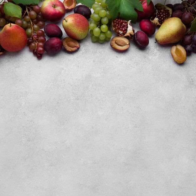 Top view arrangement of delicious autumn fruits with copy space