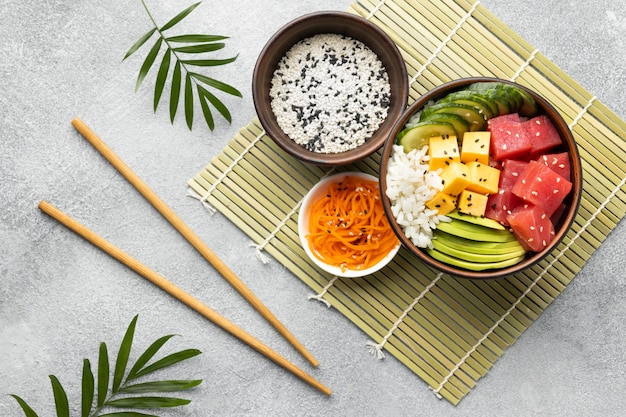 Free photo top view arrangement of delicious poke bowl