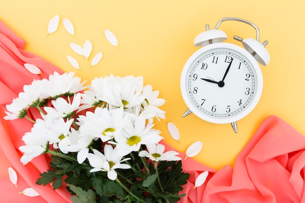 Free photo top view arrangement with bouquet and clock