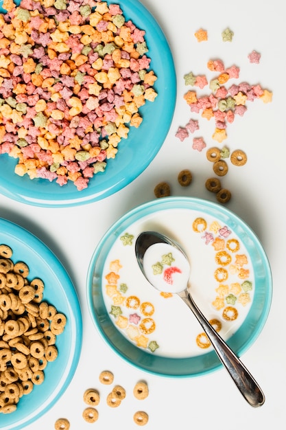 Top view arrangement with bowls and plates with cereals