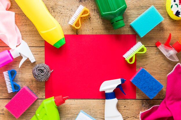 Top view arrangement with cleaning products and wooden background