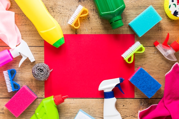 Top view arrangement with cleaning products and wooden background