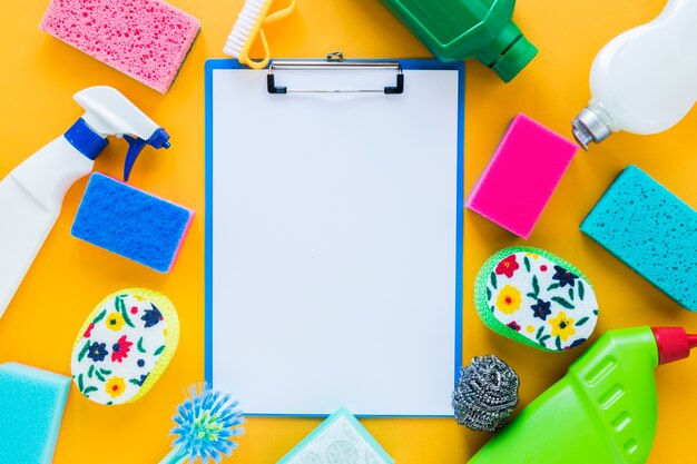 Top view arrangement with clipboard and cleaning products