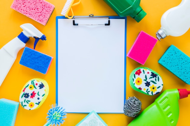 Top view arrangement with clipboard and cleaning products