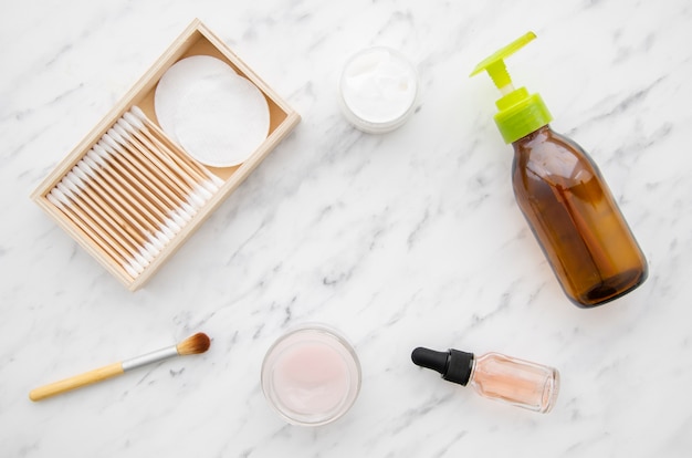 Top view arrangement with cosmetics on marble table