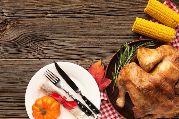 Top view arrangement with delicious meal on wooden background